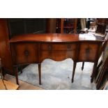 A Regency style mahogany serpentine fronted sideboard, of recent manufacture, fitted with two