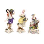Pair of German porcelain figures grape pickers along with lady seated with figures.