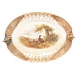 An early 20th Century Royal Worcester Vitreous oval game dish, the centre painted with pheasants and