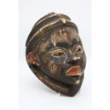 An African Tribal mask, red lifts, gold paint  Provenance: from a Private collection in Scotland