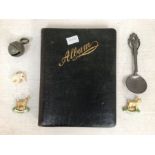 A collectors lot to include; an early 20th Century drawing album, pewter spoon, bell, badges,