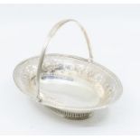 A George III silver oval small basket, reeded border and swing handle, the border with chased band