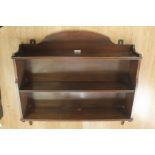 An Edwardian mahogany wall hanging shelving unit, stamped 'Fairfield S&E Co. Ltd