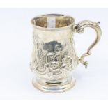 A Victorian silver baluster mug, the body chased and engraved with scrolls, flowers, foliage and