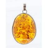 A large clarified amber and white metal pendant of irregular form, size approx 75 x 55mm, total