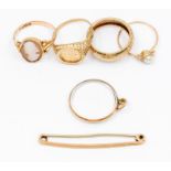 A collection of 9ct gold rings including a cameo set ring, size N, along with a textured band and