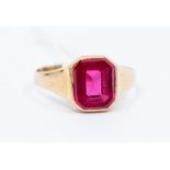A synthetic ruby and 9ct gold dress ring, comprising an emerald flat top cut synthetic ruby, size