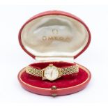 A 9ct gold ladies Omega wristwatch, round silvered dial approx 17mm, applied gold tone baton and