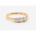 An 18ct gold three stone diamond ring, total diamond weight approx 0.30ct, platinum mount to a