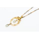 An Edwardian aquamarine and pearl set 9ct gold pendant, comprising an double oval open work form