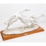 A Belcari (Italian) 20th Century group of three blanc de chine racing greyhounds, on wooden plinth