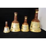Four Bells Old Scotch Whisky decanters of various sizes and two stoneware flagons, brewery related