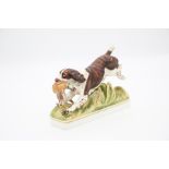 A Royal Worcester model of a Springer Spaniel retrieving a pheasant, modelled by Doris Lindner