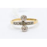 An Edwardian diamond and 18ct gold ring with a central grain set row of small rose cut diamonds,