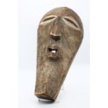 An African Tribal mask, diagonal carving to elongated face  Provenance: from a Private collection in