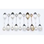 A matched set of ten early 20th Century silver teaspoons, terminal with golf clubs and club