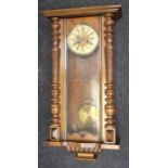 A late 19th century walnut veneered Vienna Wall Clock seven day spring driven movement with