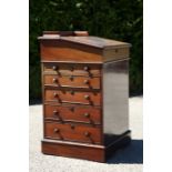 An early Victorian mahogany Davenport with leather inset top, raised on front dummy drawers with