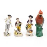 Collection of German porcelain figures including parakeet figure.