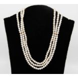 A triple strand cultured pearl necklace of 254 off round white pearls ranging from 4.5mm to 5.0 mm