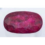 An oval cut natural Ruby, 672.3ct, 68.98 x 41.40 x 22.63mm, colour enhanced, opaque, as per