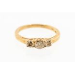 A cognac diamond three stone 9ct gold ring, comprising three round cognac diamonds, claw set