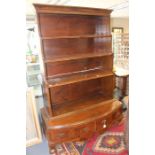An early 20th Century waterfall bookcase on stand, the upper and lower sectioned married at a