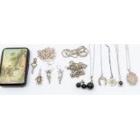A collection of silver jewellery to include a rose quartz set locket, a garnet stone set pendant,