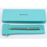 Tiffany & Co- a two tone Tiffany & Co ball point pen, with signature turquoise pouch and box.