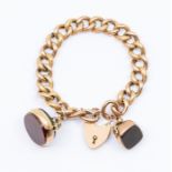 An Edward VII 9ct rose gold heavy curb link bracelet with padlock clasp suspending two double swivel