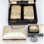 A group of silver to include: early 20th Century cigarette case (damaged); napkin ring oval (boxed);