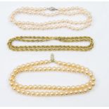 Two faux pearl necklaces including one by Lotus with silver clasp, along with a gilt metal chain,