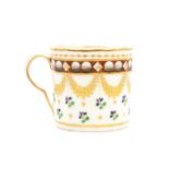 A Pinxton coffee cup, facetted, the body decorated with gilt rim above band of circular and
