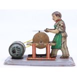 Arnold: A mid-20th century, tinplate, clockwork man sharpening a knife, untested, appears