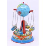 Tinplate: A tinplate globe carousel, West German, Made by J.W., comprising four spinning vehicles,