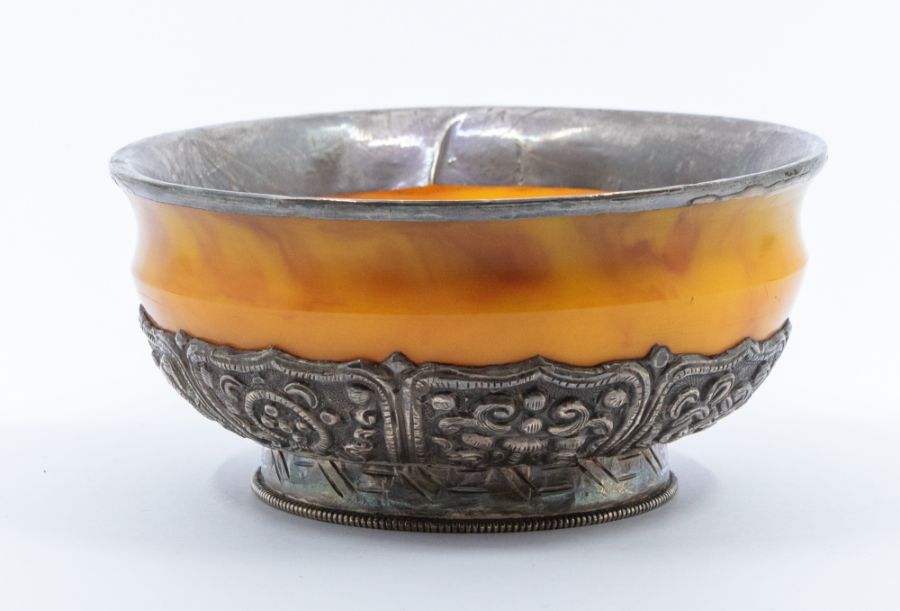 A Bhutan silver-mounted amber bowl, the base of the bowl with lappets decorated in repoussé with the - Image 2 of 4