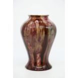 A Bernard Moore mottled flambe baluster shaped vase, semi iridescent brown over pink streaked glaze.