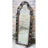 An early 18th century style black-lacquered mirror in a fiat-sprigged arched flat frame