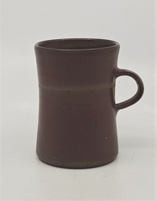 A studio pottery earthenware mug, dark brown glaze, height 10cm.  *purchased as by Lucie Rie by