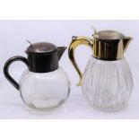 A near pair of large silver plated Claret jugs