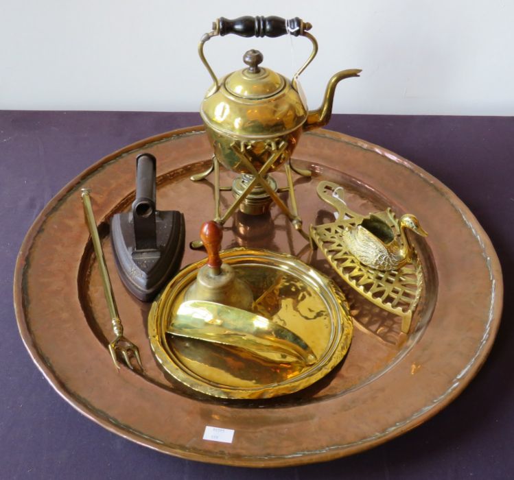An Arts and crafts style copper circular tray, a Victorian brass kettle on a stand, a metal