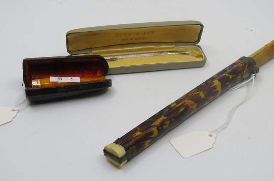 A "Yard o led" engine turned 9ct gold propelling pencil in original box, an amber coloured cheroot