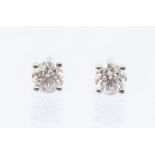 A pair of diamond and 18ct stud earrings, claw set brilliant cut diamonds weighing a total approx