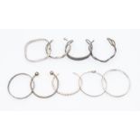 A collection of nine silver bangles and cuffs including various designs, hinged, rope twist and a
