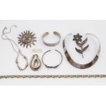 A collection of silver jewellery to include a plain collar, a mid century brooch marked Spain