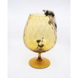 Beswick cat on large glass brandy glass with mouse figure sat in base of glass.