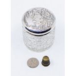 An early 20th Century cut glass silver mounted dressing table bottle, the cover chased with Art