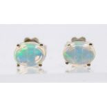 A pair of silver and Ethiopian opal stud earrings, claw set with oval cabochon opals, approx. 7 x