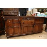 A 20th Century Nigel Griffiths oak side board with three cupboard doors and three top drawers in oak