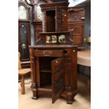 Late 19th Century oak corner unit with carved frog and lizard panel, above two mirror panels,